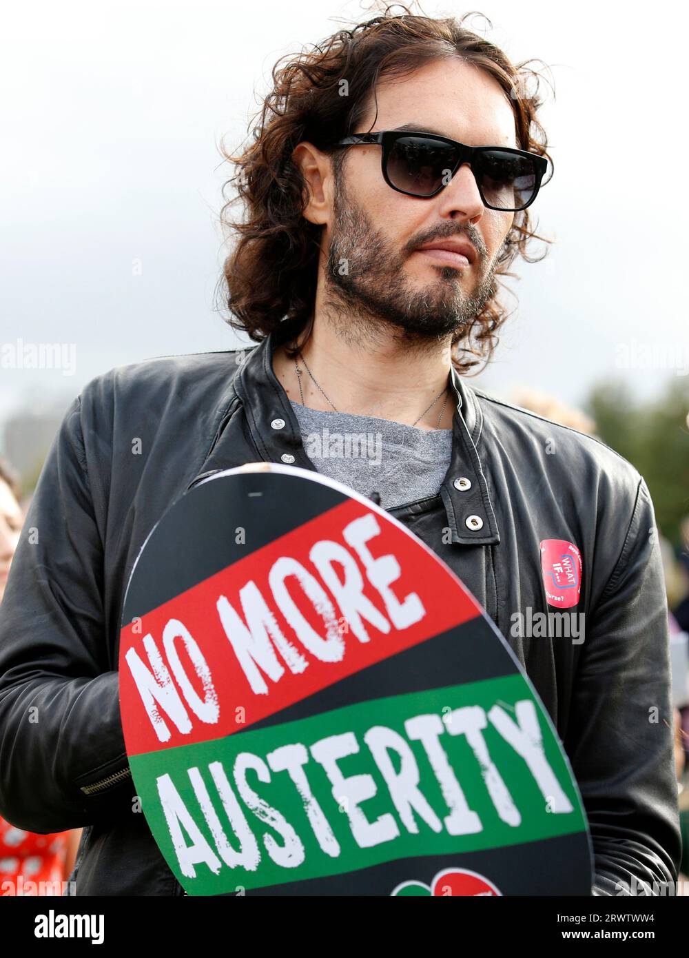 Russell Brand stands amongst the crowd listening to speeches at the TUC Rally 'Britain needs a pay rise' in Hyde Park, in London on 18 October, 2014. Stock Photo