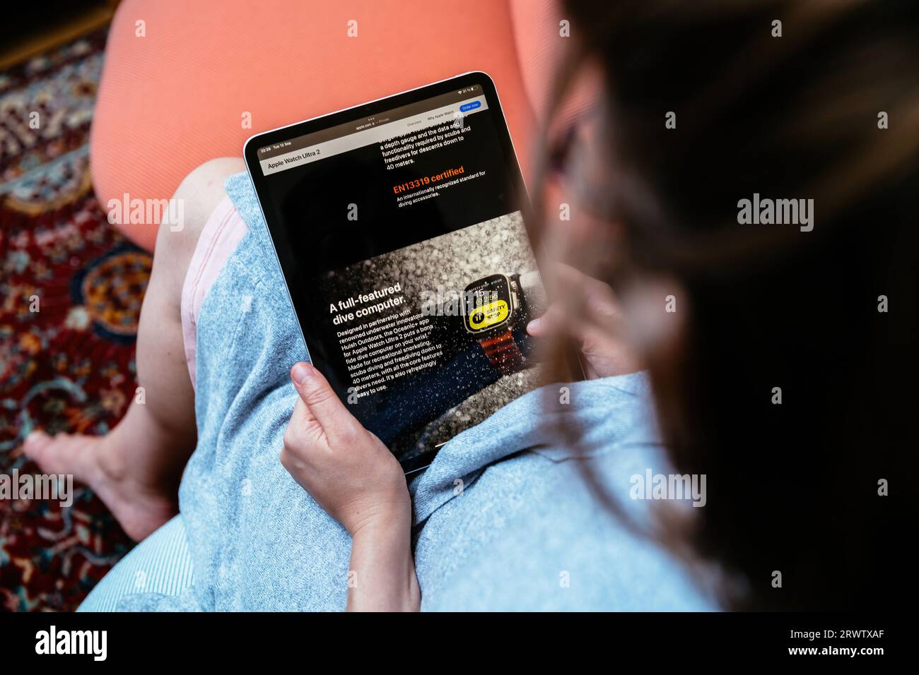 London, UK Sep 13, 2023 , a woman holds her iPad Pro, perusing Apple