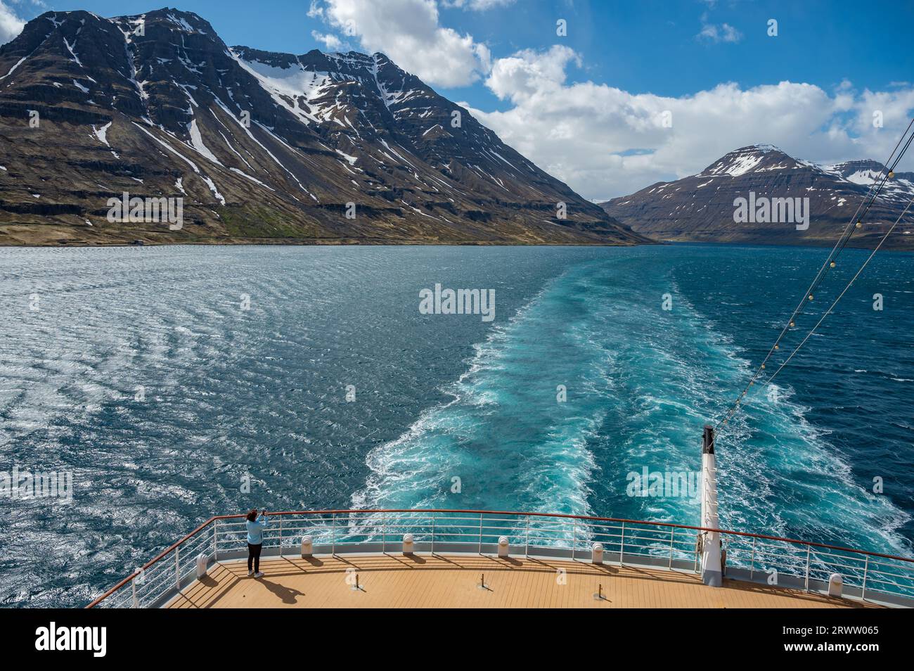 Rear view from a cruise ship on a fjord near Seydisfjordur, iceland, mountain range in the background Stock Photo
