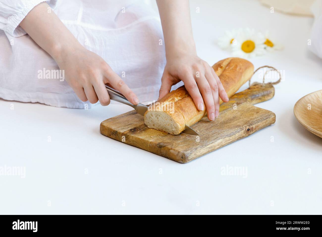 Woman using a dough cutter to divide the naan bread dough into six equal  portions which are flattened and baked. Bakers and pas Stock Photo - Alamy