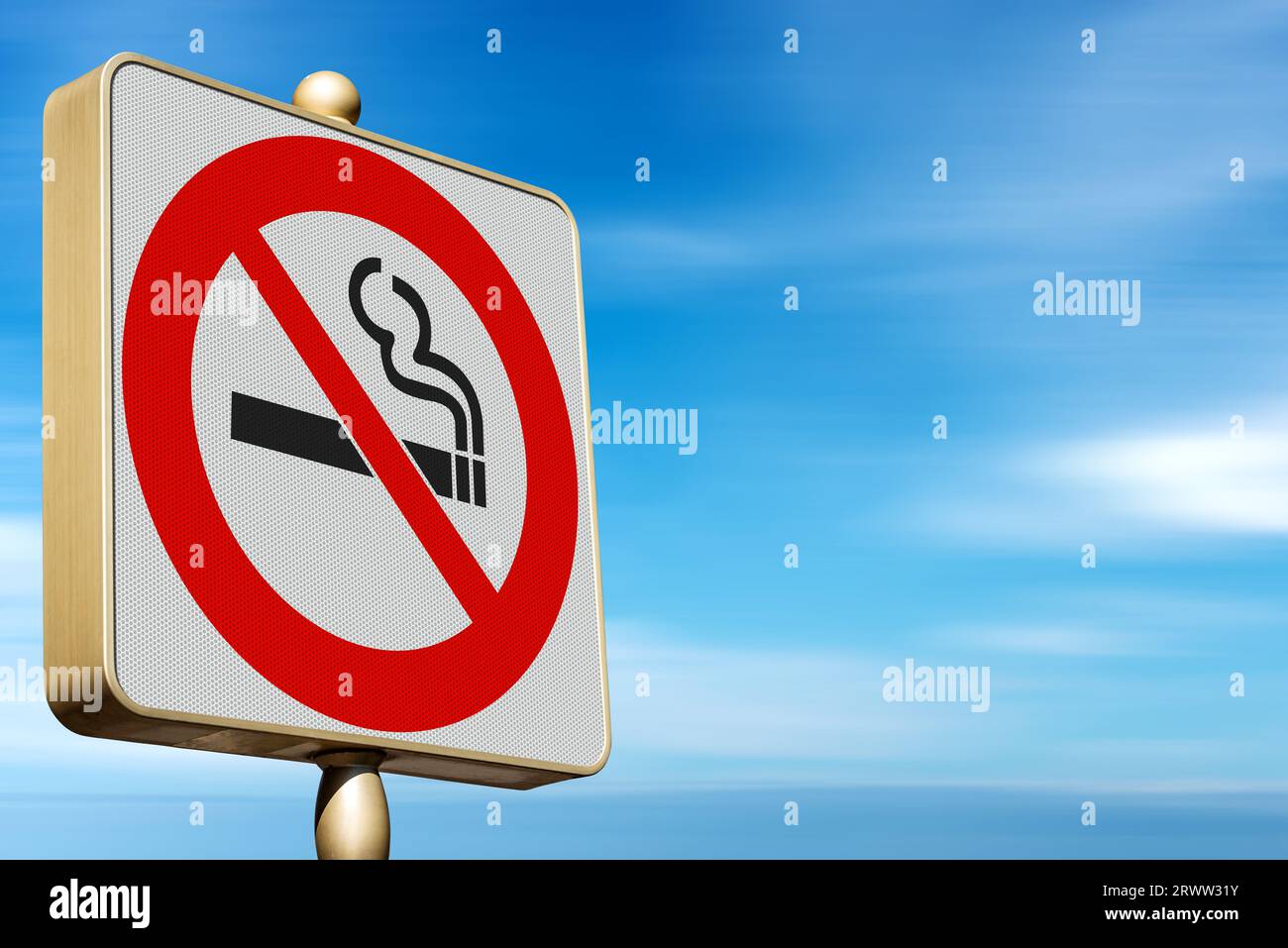 Close-up of a modern smoking prohibited sign. No smoking road sign against a clear blue sky and clouds with copy space. Stock Photo