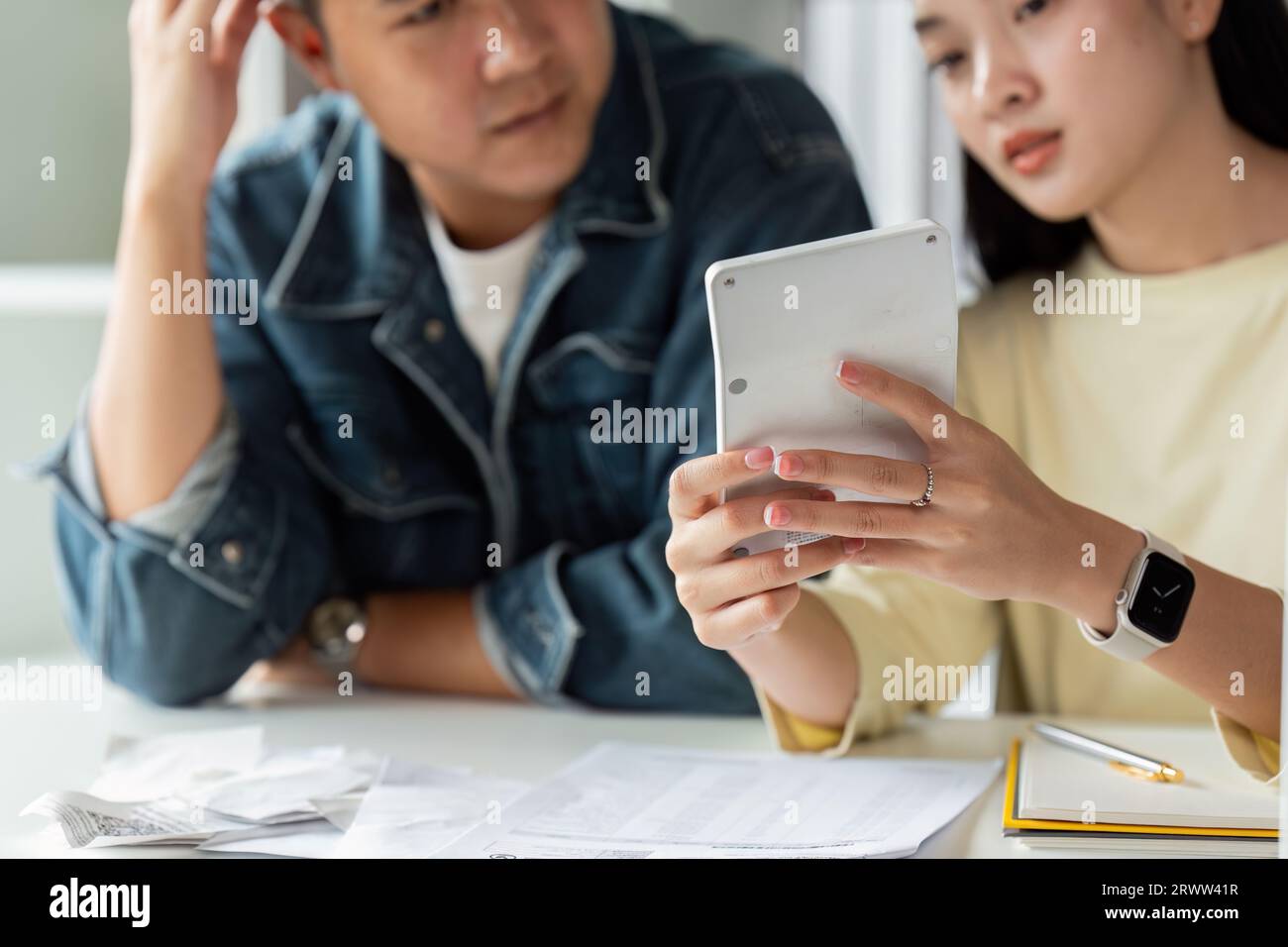 Stressed Asian young couple confused calculate expense from invoice or ...