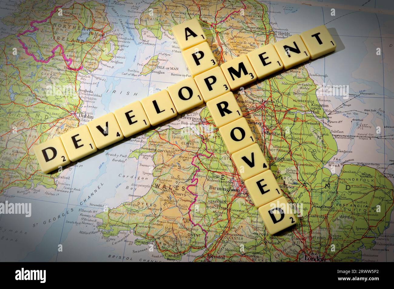 Development Approved spelled out in Scrabble letters and words on a map of England - local development and building control Stock Photo