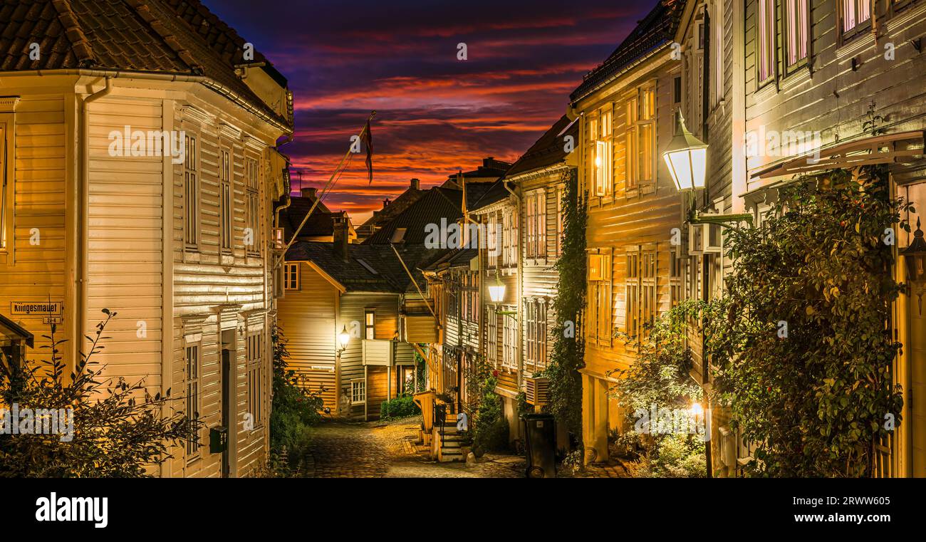 Spectacular sunset among the old, wooden houses in the centre of Bergen, Norway. A street called Nedre Stølen in the northern part of the city centre. Stock Photo