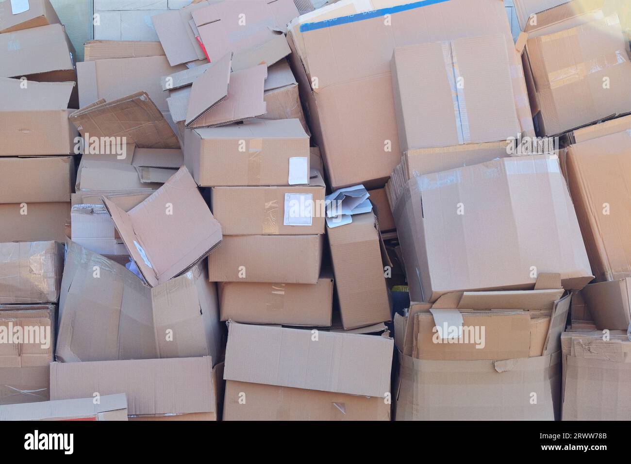 Cardboard and waste paper is packaged for recycling. Pile of cardboard