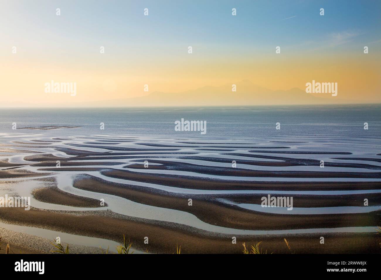 Sea Setting Example Sand pattern, sea, setting sun, and Mt Stock Photo - Alamy