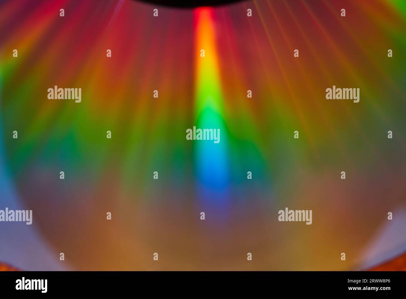 Bright streak of light on reflective abstract surface of rainbow colors like aurora lights Stock
