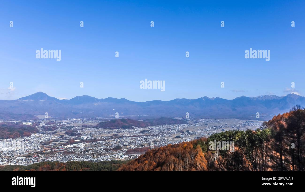 View of the Yatsugatake mountain range over the Chino cityscape Stock Photo