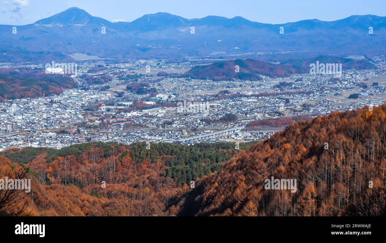 View of the Yatsugatake mountain range over the Chino cityscape Stock Photo