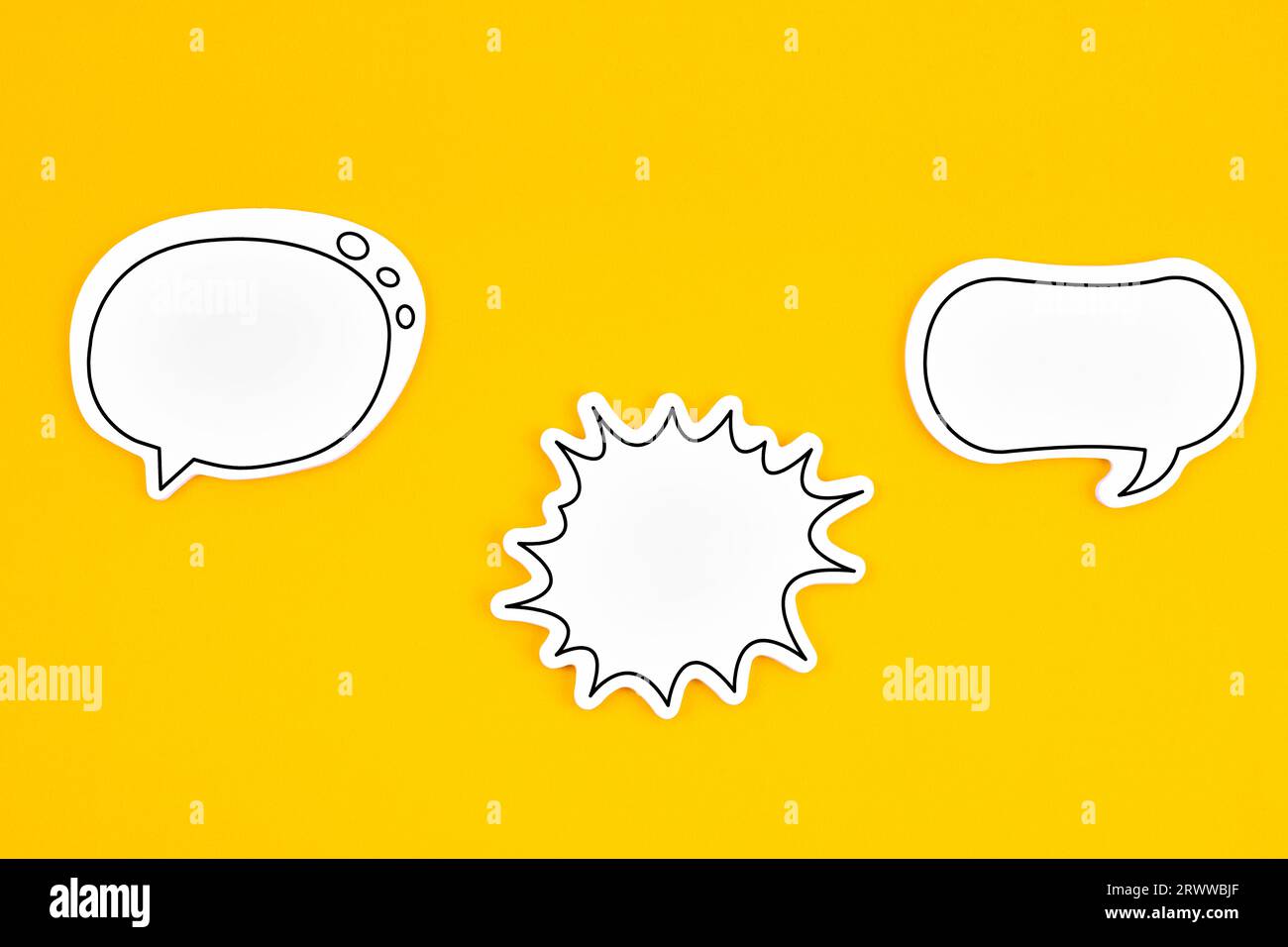 Blank white speech bubble isolated on yellow background. Stock Photo