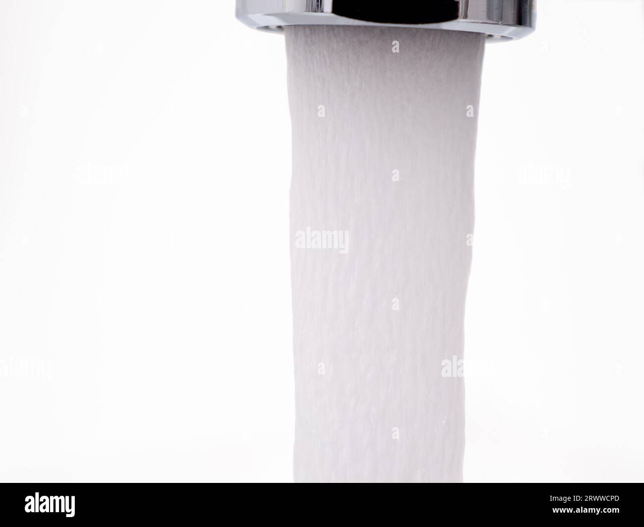 Water flows from a tap, water pressure on a white background. A stream