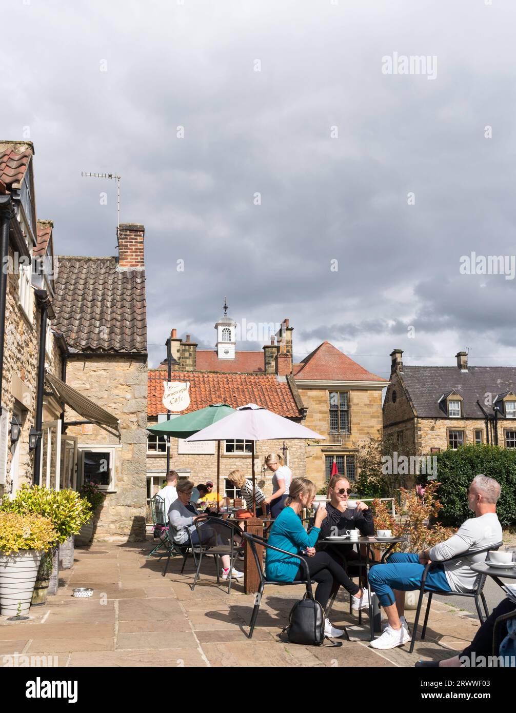 People sitting outside a café in Helmsley, North Yorkshire, England, UK Stock Photo