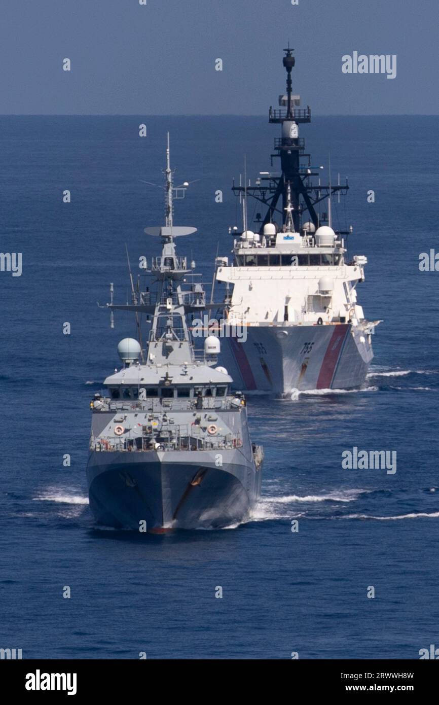 South China Sea, International Waters. 17 September, 2023. The British Royal Navy River-class offshore patrol vessel HMS Spey, left, leads the U.S. Coast Guard Legend-class cutter USCGC Munro, during coordinated ship maneuvers in international waters, September 17, 2023, on the South China Sea.  Credit: CPO Brett Cote/US Navy Photo/Alamy Live News Stock Photo