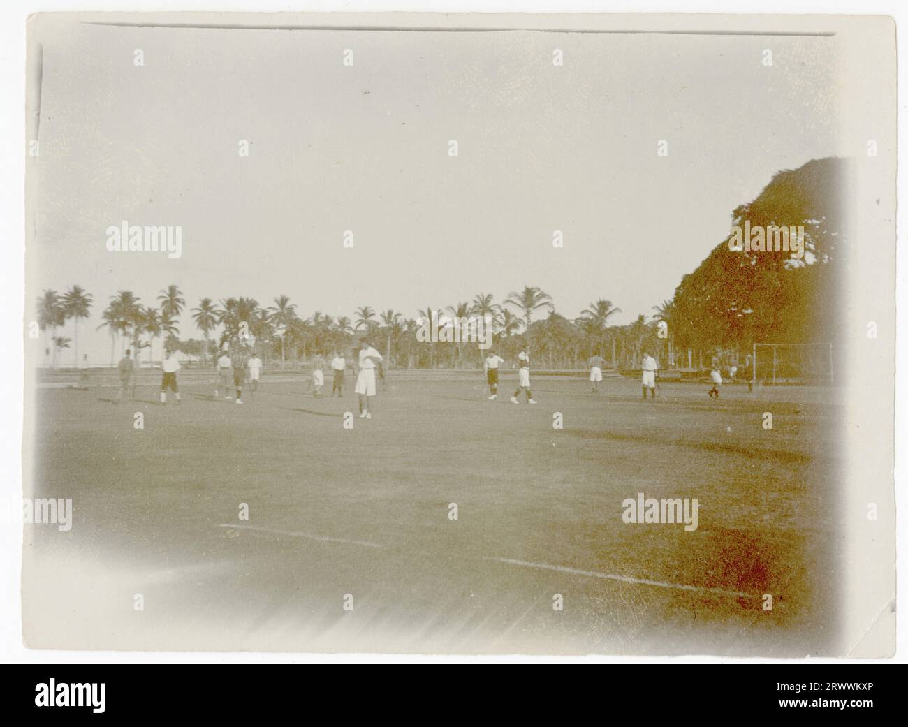 Shows a palm tree fringed playing field, on which a game of hockey is in progress. Caption on reverse reads: Hockey Ground, Aberdeen Island, Andamans. Stock Photo