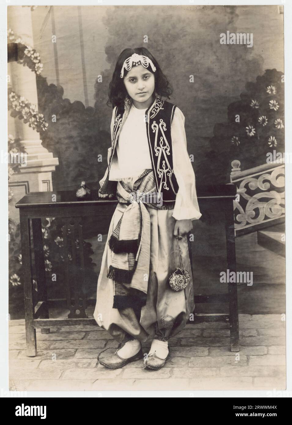 Portrait of young girl in traditional dress. This was a friend of one of the Khan family. Caption reads: 41 - Young girl (unidentified) dressed for a Christmas Pantomime. Probably Lahore, studio. C 1941 - 42 (ref not one of Sir Sikander's 10 children). Stock Photo