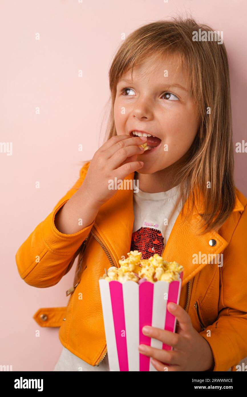 Little girl eating sweet popcorn Stock Photo Alamy