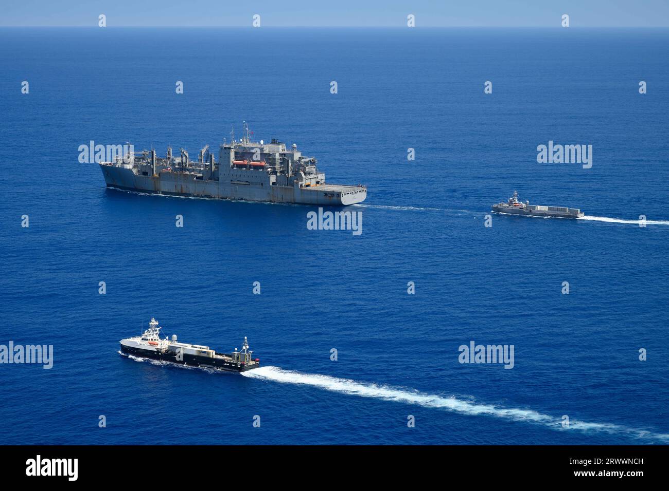 Pacific Ocean, United States. 16 September, 2023. The U.S Navy unmanned surface vessel USV Ranger, right, approaches for replenishment-at-sea with the Lewis and Clark-class dry cargo and ammunition ship USNS Charles Drew as the sister ship USV Mariner, bottom, follows along during Integrated Battle Problem 23.2, September 16, 2023 on the Pacific Ocean. The Pacific Fleet exercise is to test, develop and evaluate the integration of unmanned platforms into fleet operations.  Credit: MC2 Jesse Monford/US Army/Alamy Live News Stock Photo