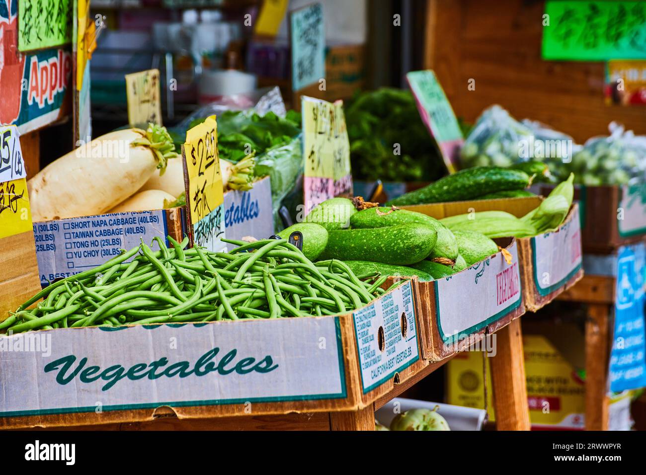 Open air market with fresh green vegetables on wooden table Stock Photo