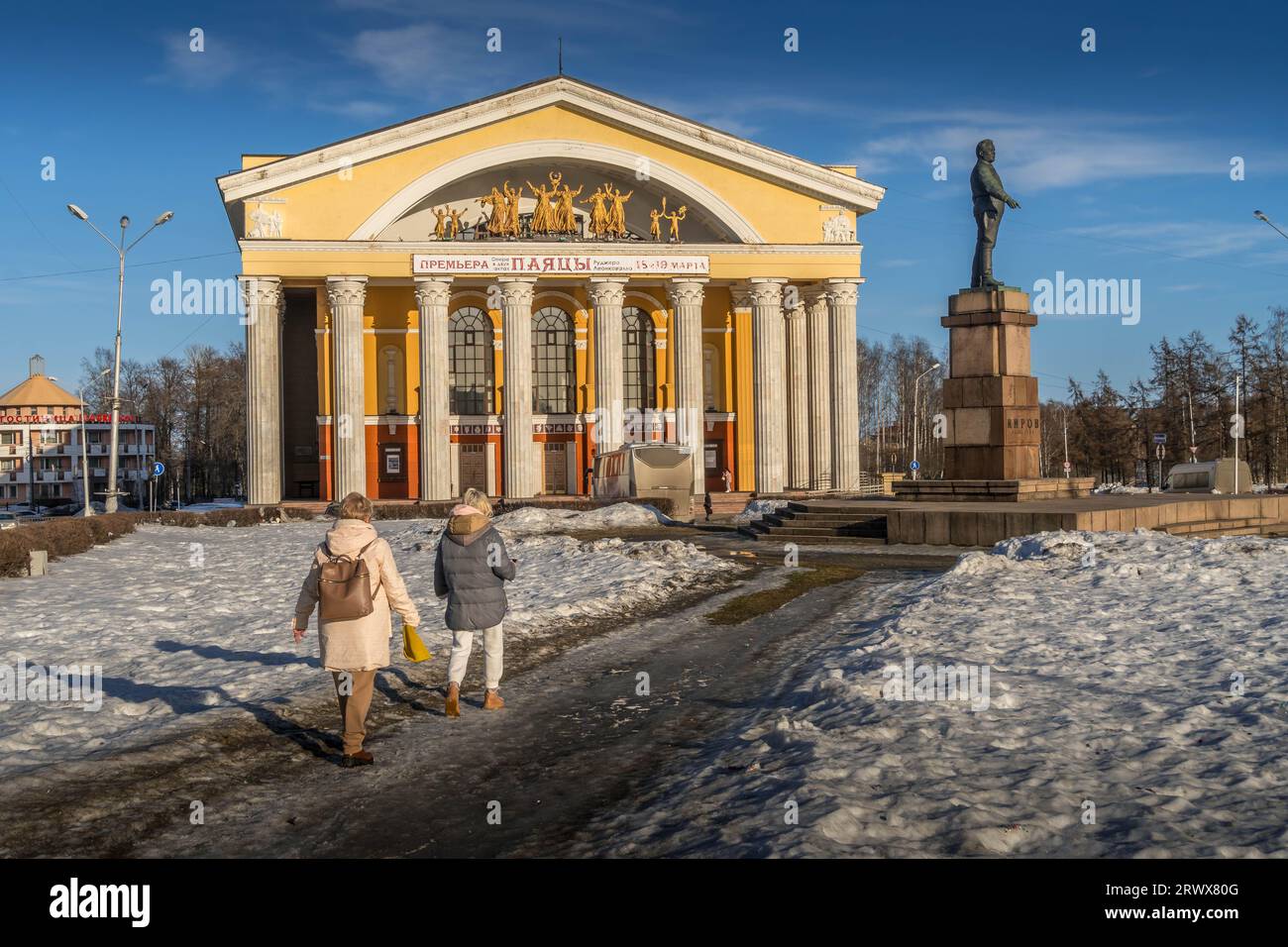 The people walk by the city plaza in front of the Kirov's monument and the theater building during the winter in Petrozavodsk, Karelia, Russia. Stock Photo