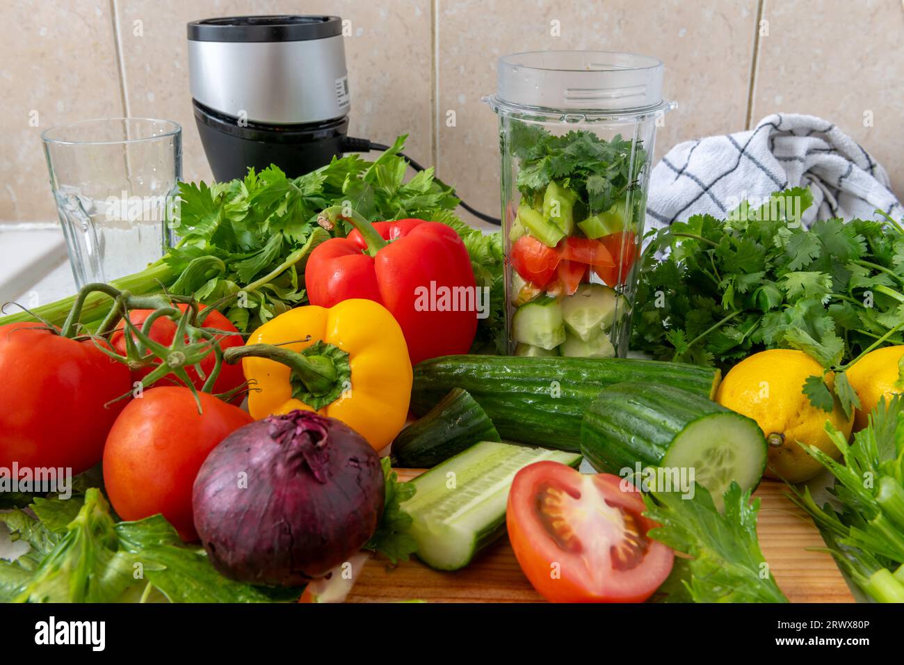 Making vegetable smoothie with fresh vegetables in a blender. Health food and living concept. Stock Photo