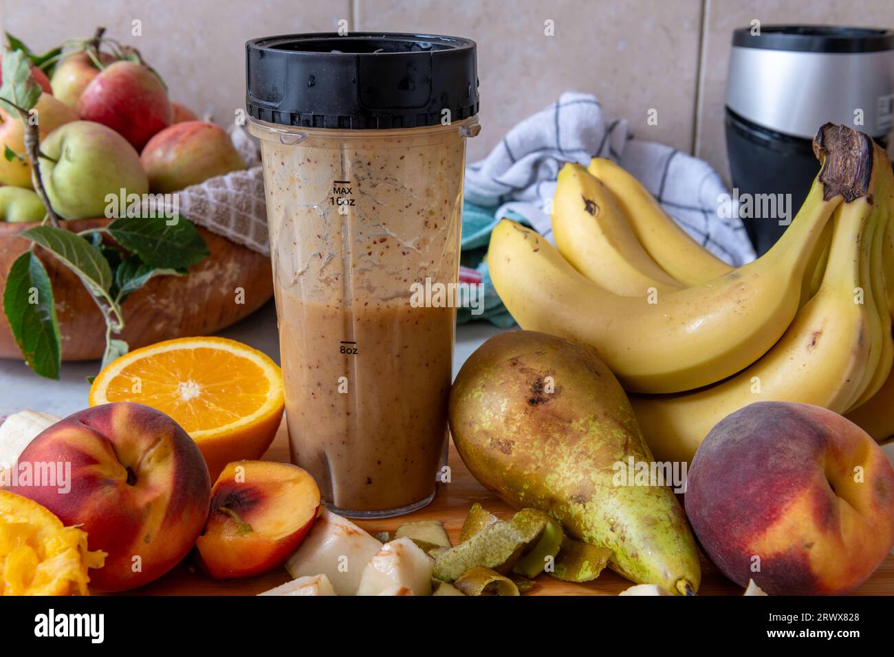 Making a smoothie with fresh fruits in a blender. Healthy life style, health food concept. Stock Photo
