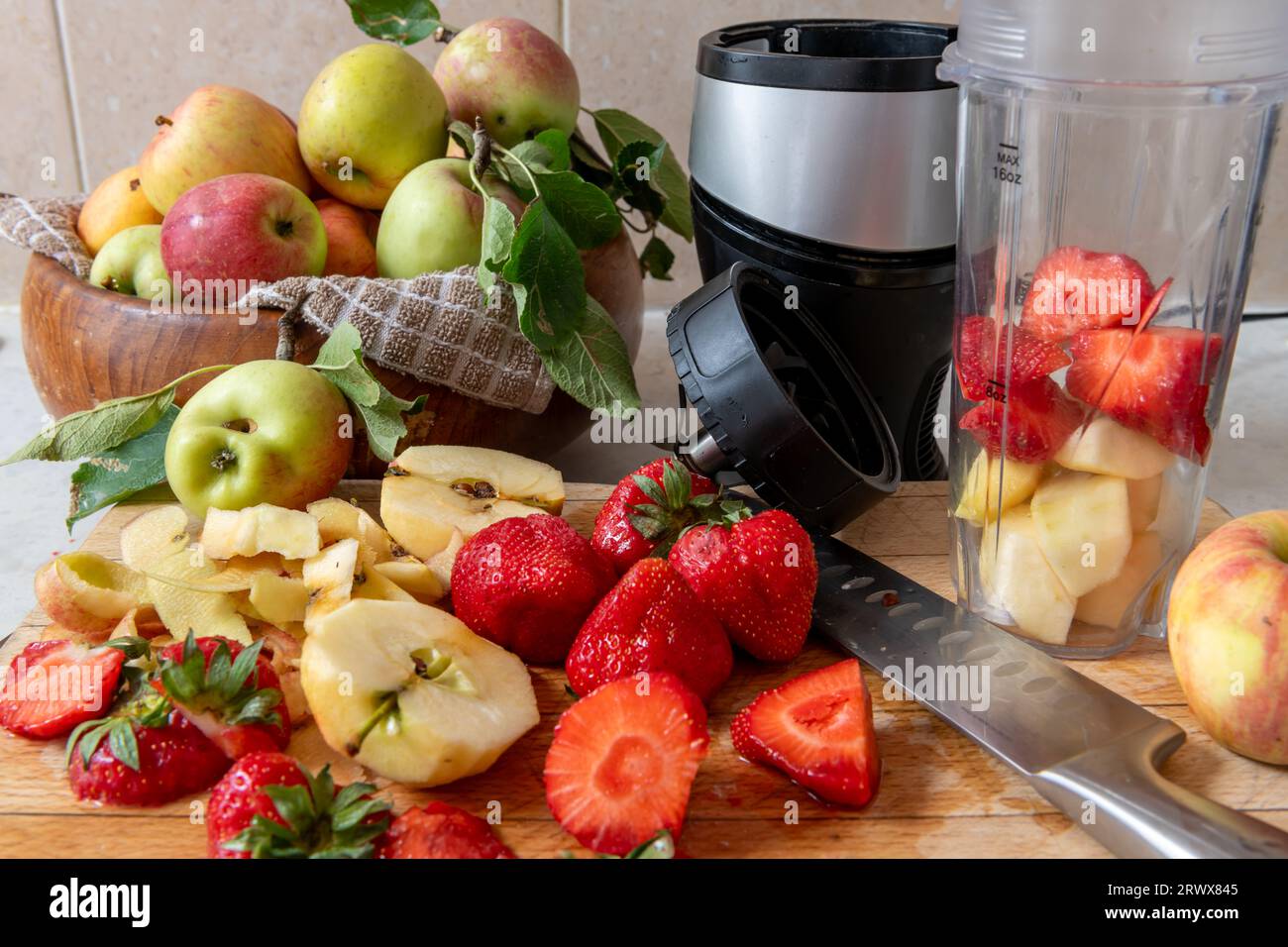 Making a smoothie with fresh fruits in a blender. Healthy life style, health food concept. Stock Photo