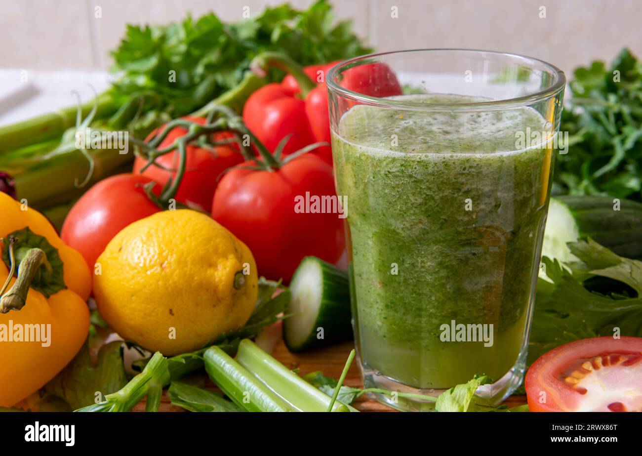 A glass of smoothie made with a blend of healthy raw vegetables. Healthy lifestyle and living concept. Stock Photo