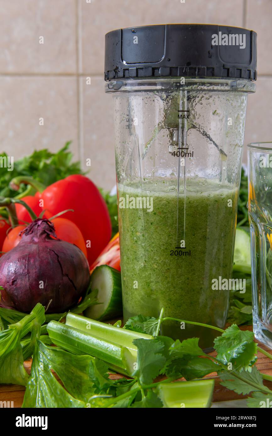 Making vegetable smoothie with fresh vegetables in a blender. Health food and living concept. Stock Photo