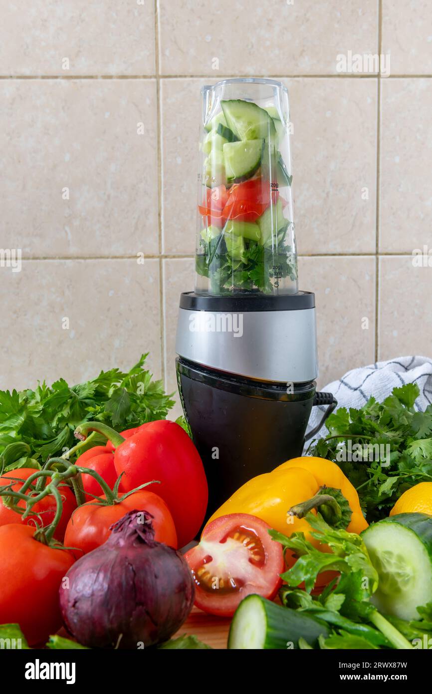 Making vegetable smoothie with fresh vegetables in a blender. Health food and living concept. Stock Photo