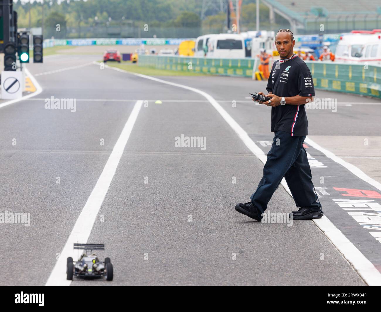Suzuka Grand Prix Circuit, 21 September 2023: Lewis Hamilton (GBR) of team Mercedes operates a remote controlled car in a race with Esteban Ocon (FRA) of team Alpine during the 2023 Japan Formula 1 Grand Prix. corleve/Alamy Live News Stock Photo