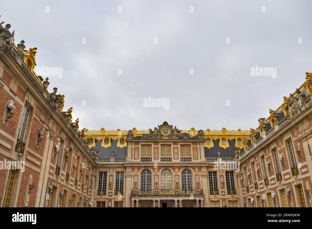 Front entrance of the Palace of Versailles in France with ornate gold leaf detail and French Baroque or classicism architectural style Stock Photo