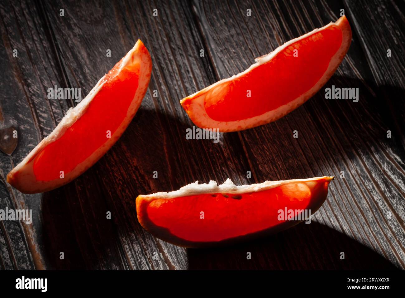 sliced grapefruit on wood background Stock Photo