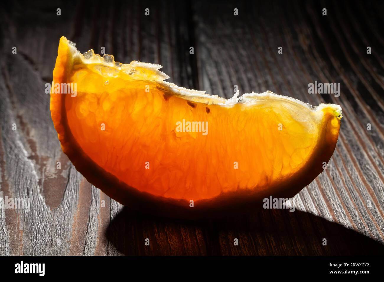 sliced orange on wood background Stock Photo