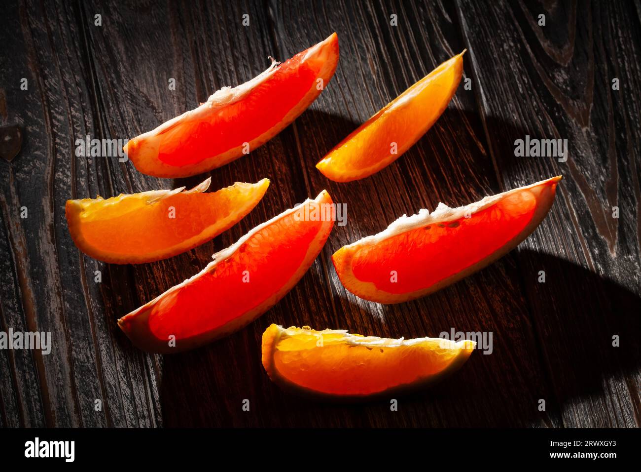 sliced grapefruit orange on wood background Stock Photo