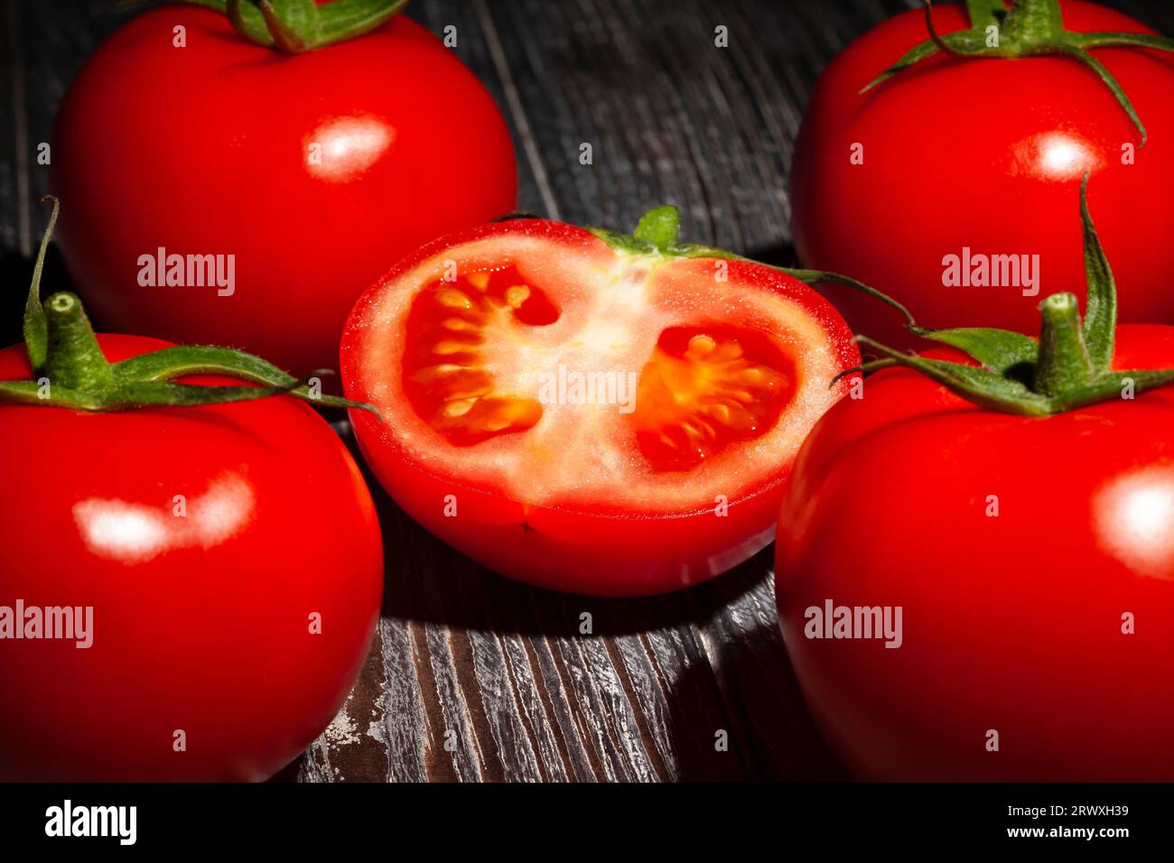 sliced tomato on wood background Stock Photo
