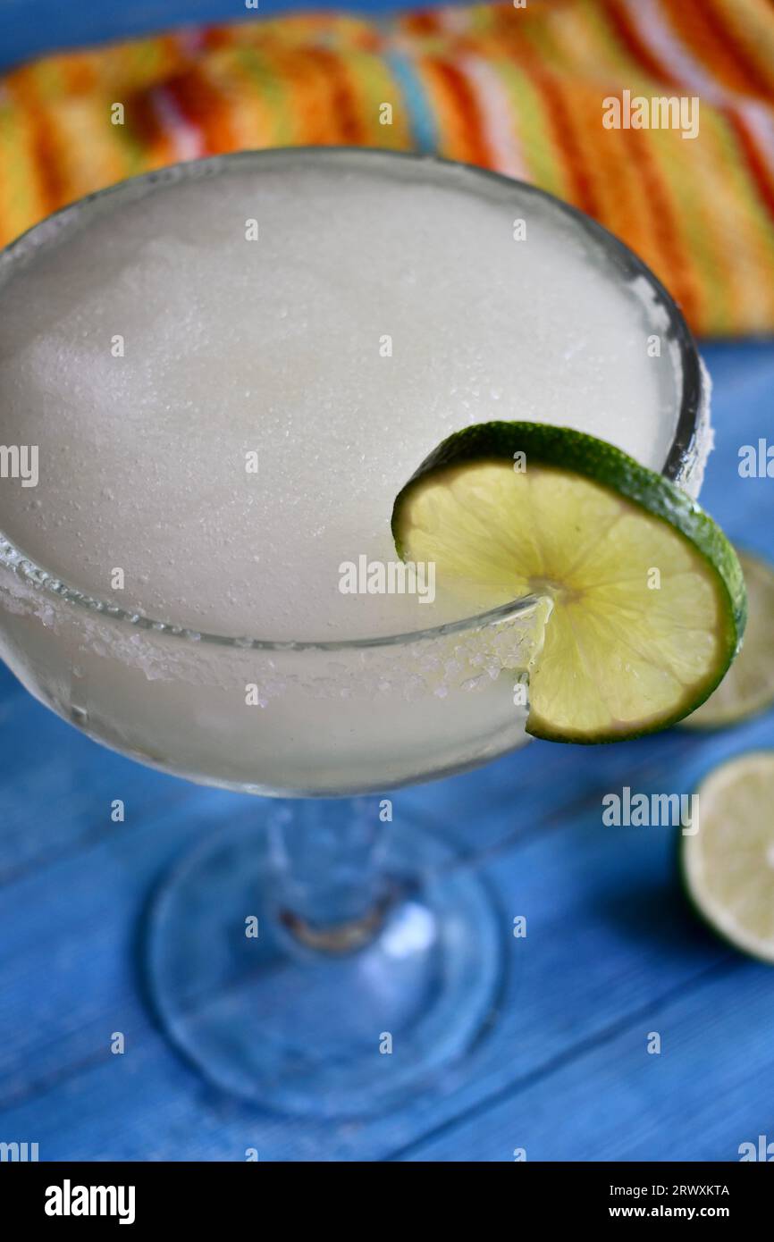 Classic frozen margarita in a clear glass with lime slice Stock Photo