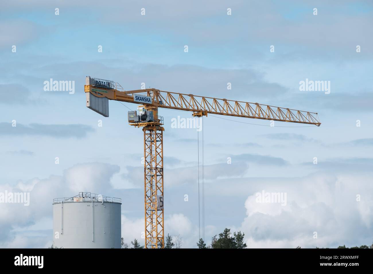 Helsinki / Finland - SEPTEMBER 18, 2023: A construction crane against a bright blue sky. Operated by Swedish multinational construction and developmen Stock Photo