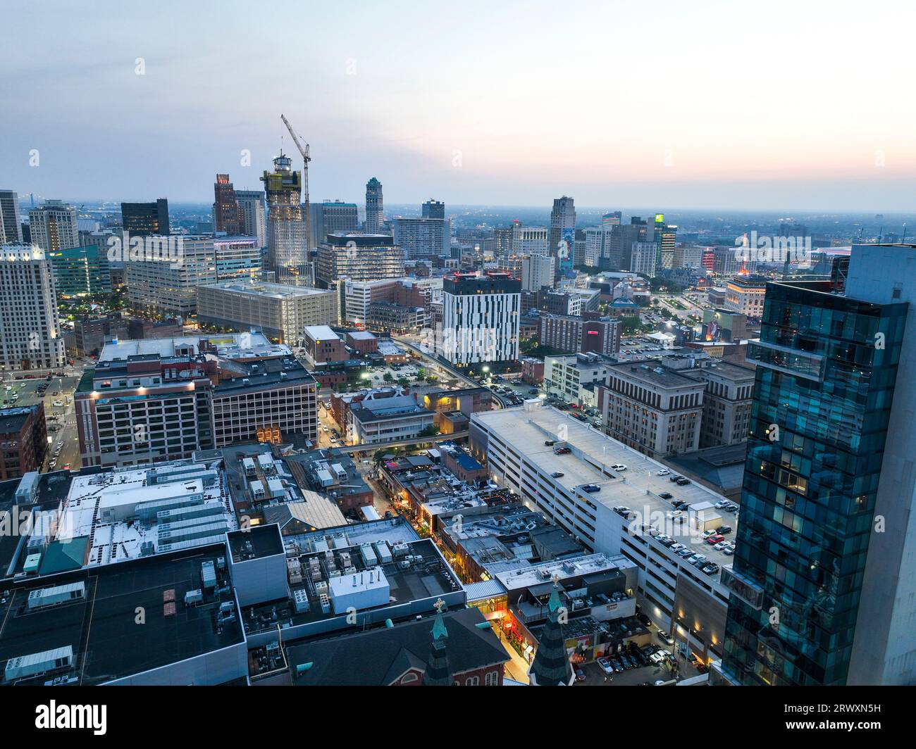 Aerial view of a bustling city at sunset, with a multitude of tall ...