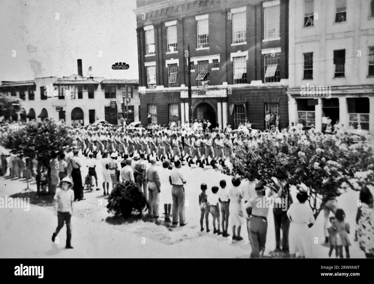 Parade at Riverside, California:  Marching in the street. Rare photograph: From a collection compiled by an unknown British serviceman covering the No. 1 Composite Demonstration, AA Battery, tour of the USA, from July 11th 1943. This is one from over one hundred images in the collection which were on average around 4x3 inches. Stock Photo