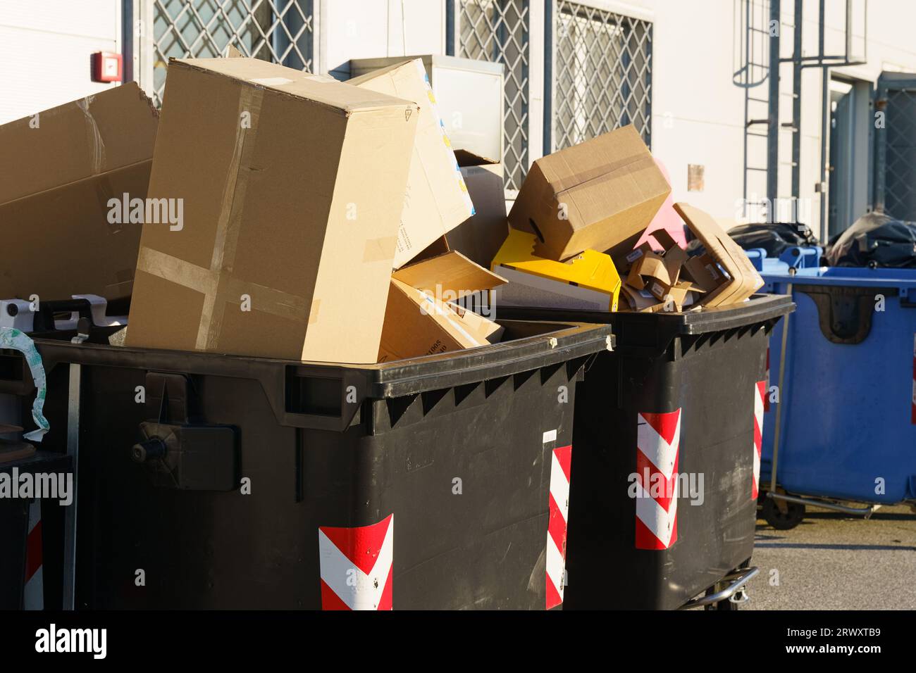 Def Box Garbage The black trash cans are filled to the brim with cardboard boxes Stock ...