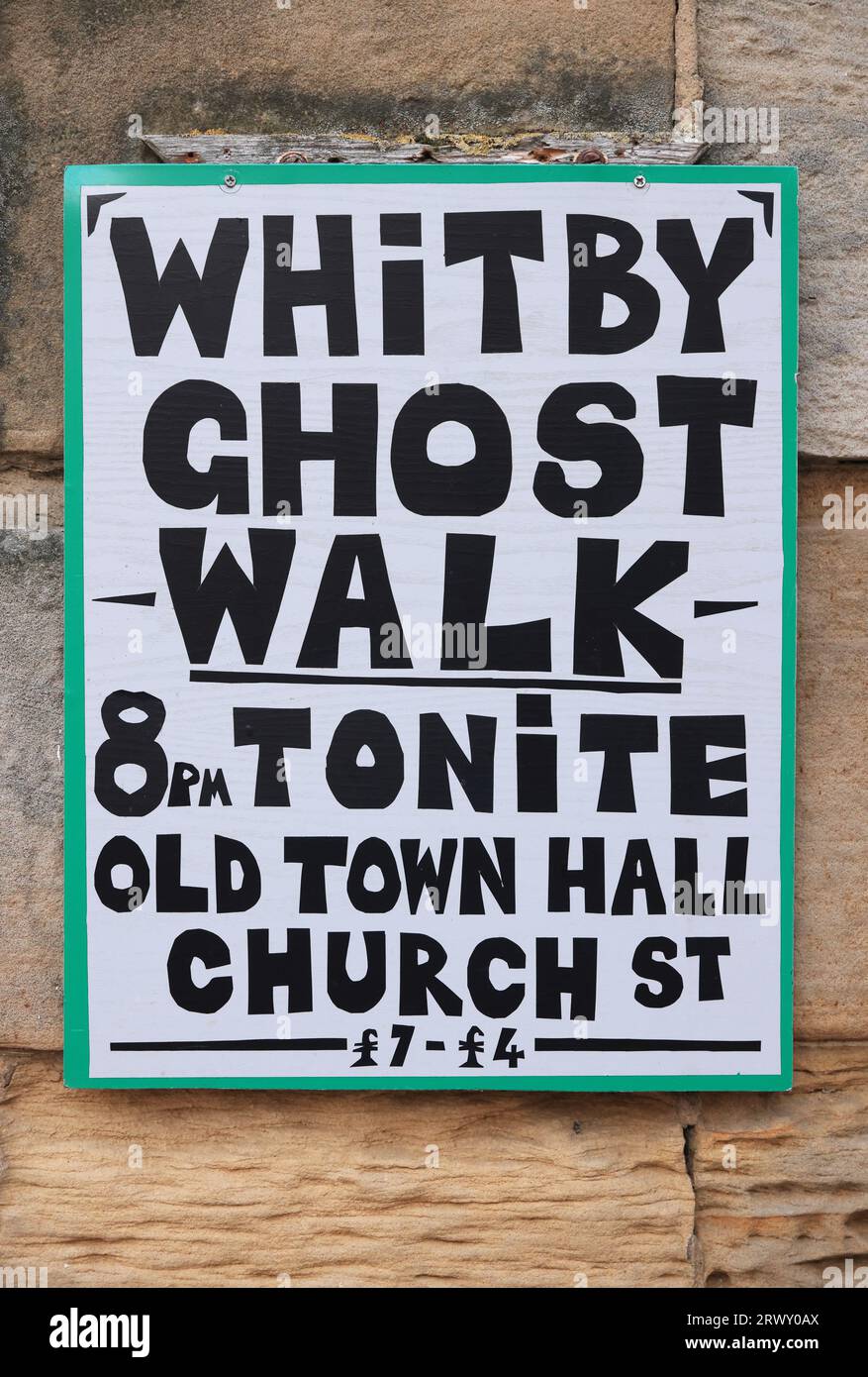 Signs for a Ghost Walk on cobbled Church Street in the historic old town of Whitby in North Yorkshire, UK Stock Photo