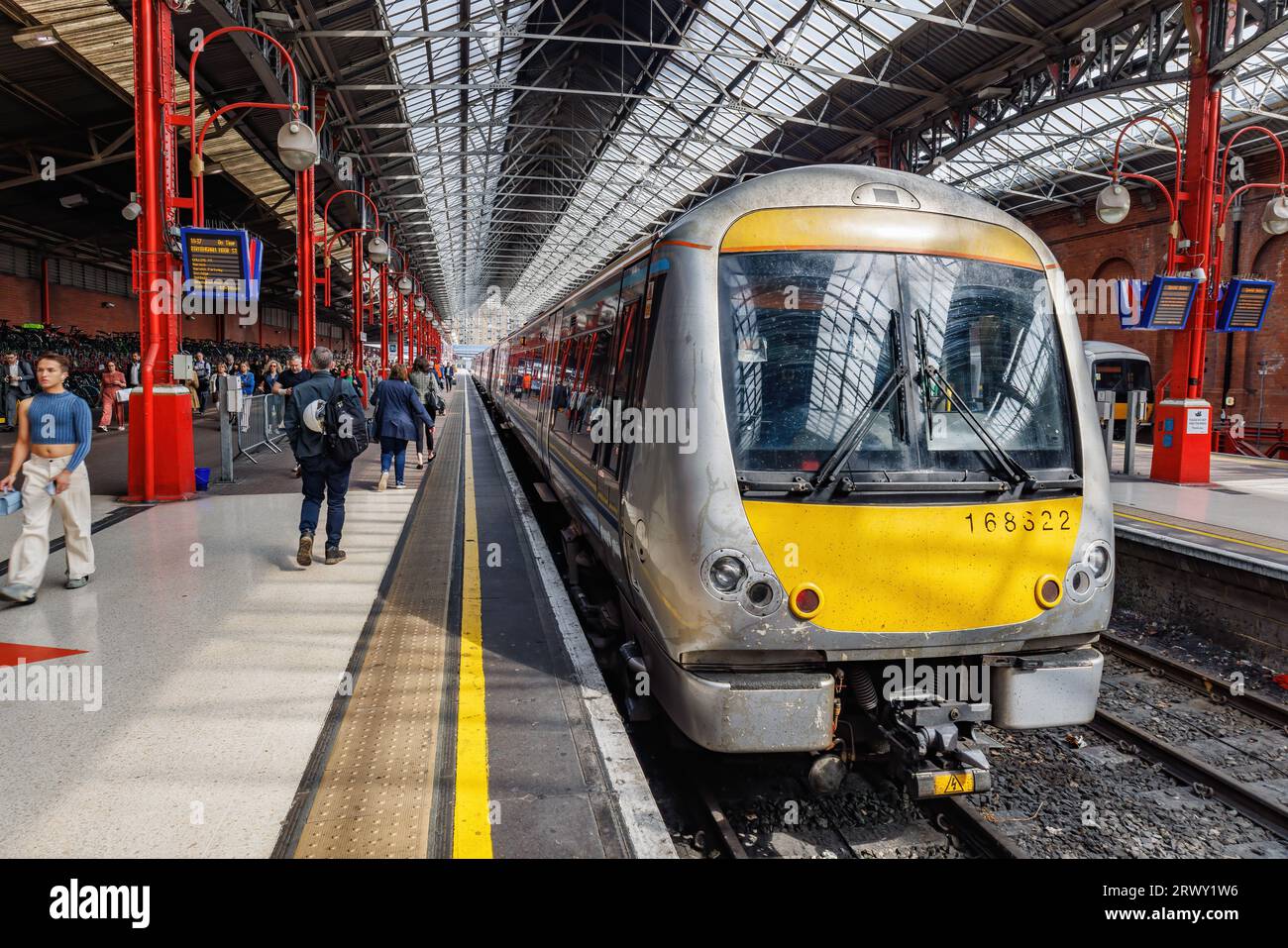London, UK - May 18, 2023:  A commuter train at the railway platform about to leave the station Stock Photo
