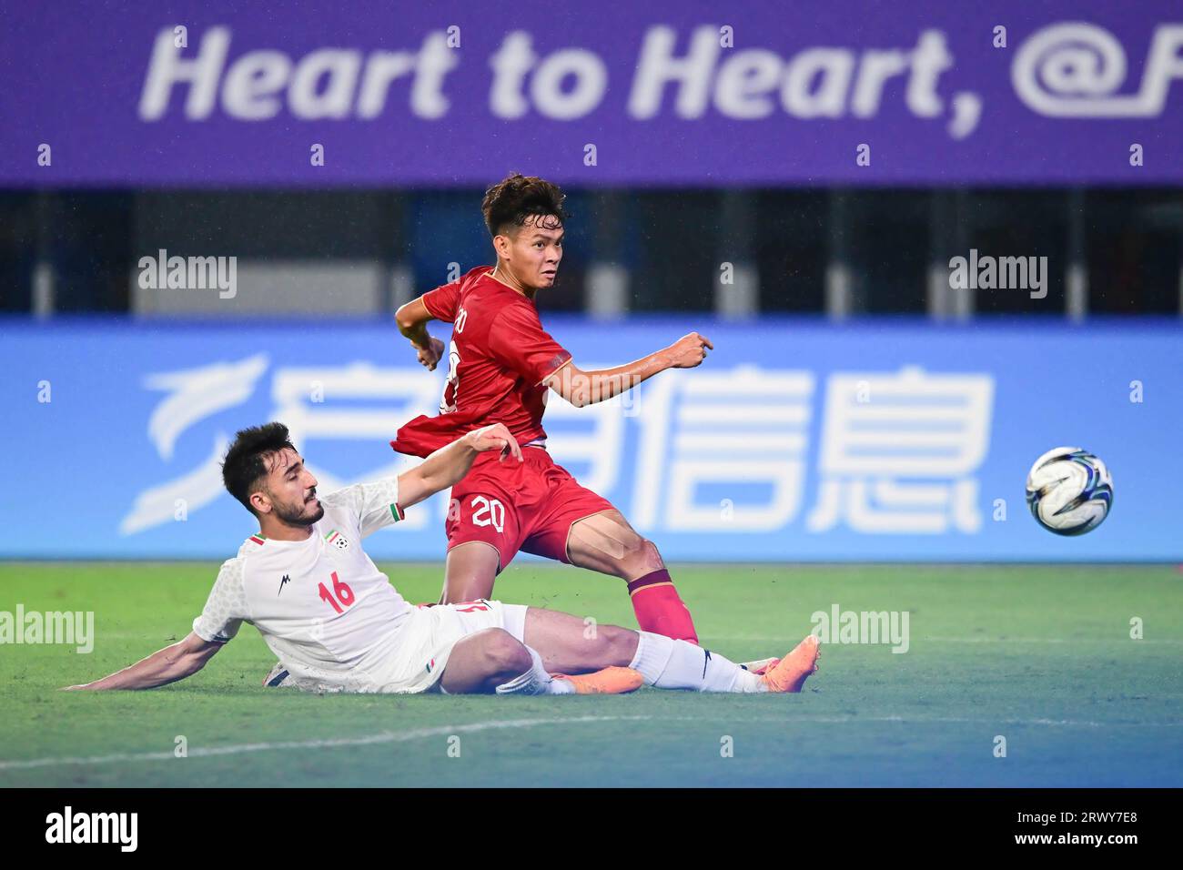 Hangzhou, China. 21st Sep, 2023. Seyedmajid Nasiri of the Islamic Republic of Iran men football team and Vi Hao Bui of the Vietnam men football team are seen in action during the 19th Asian Games men's football group round Group B match between Islamic Republic of Iran and Vietnam held at the Linping Sports Centre Stadium. Final score Islamic Republic of Iran 4:0 Vietnam. (Photo by Luis Veniegra/SOPA Images/Sipa USA) Credit: Sipa USA/Alamy Live News Stock Photo