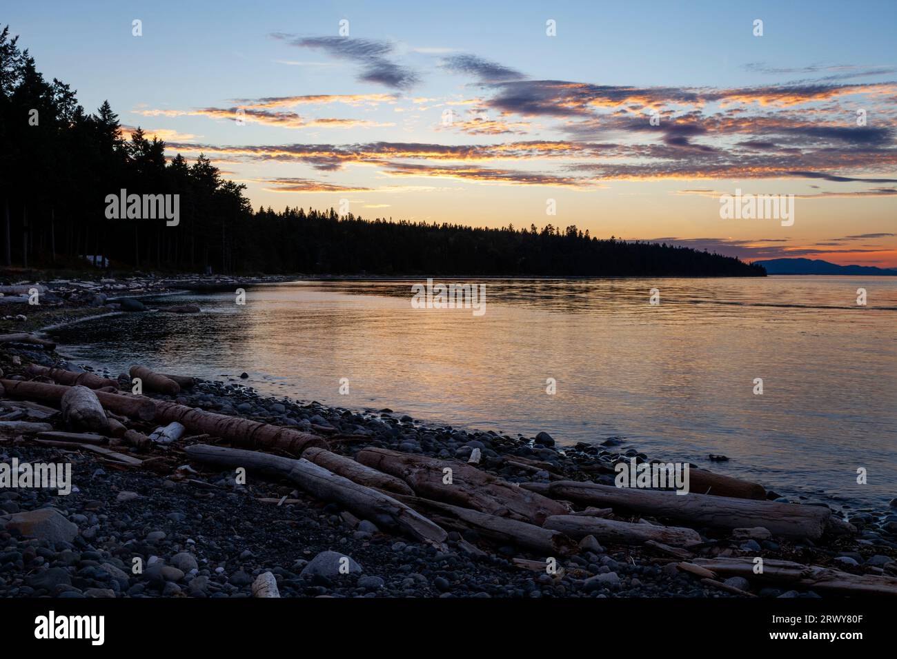 Sunset on the eastern shoreline of Vancouver Island in British Columbia at Kitty Coleman Beach Provincial Park Stock Photo