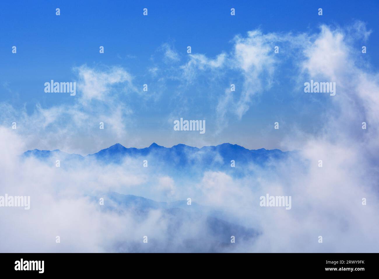 Gushing Clouds and Southern Alps Mountains Stock Photo