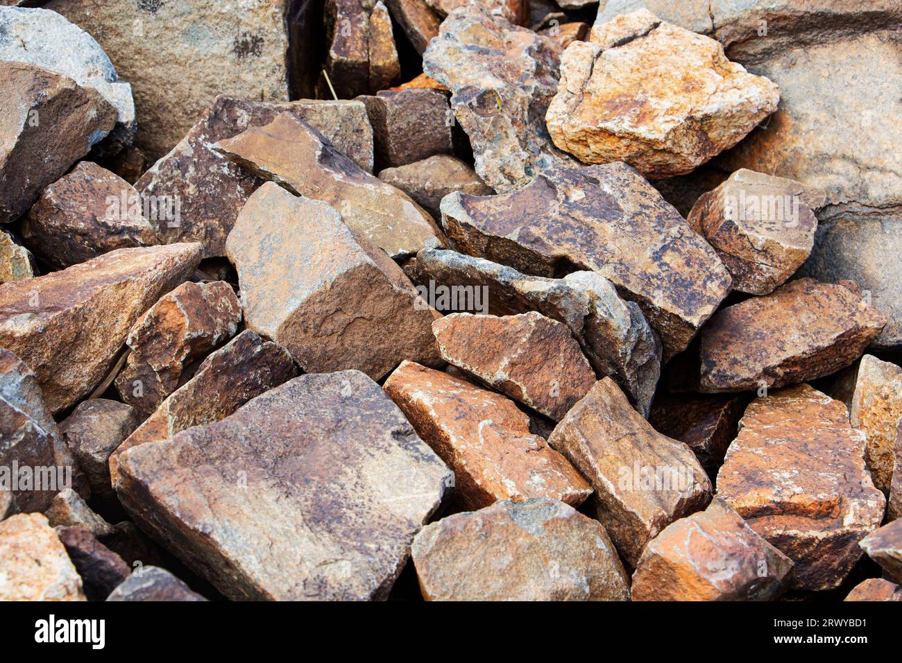 Rockfall on the road in the mountains. Stones of different sizes ...