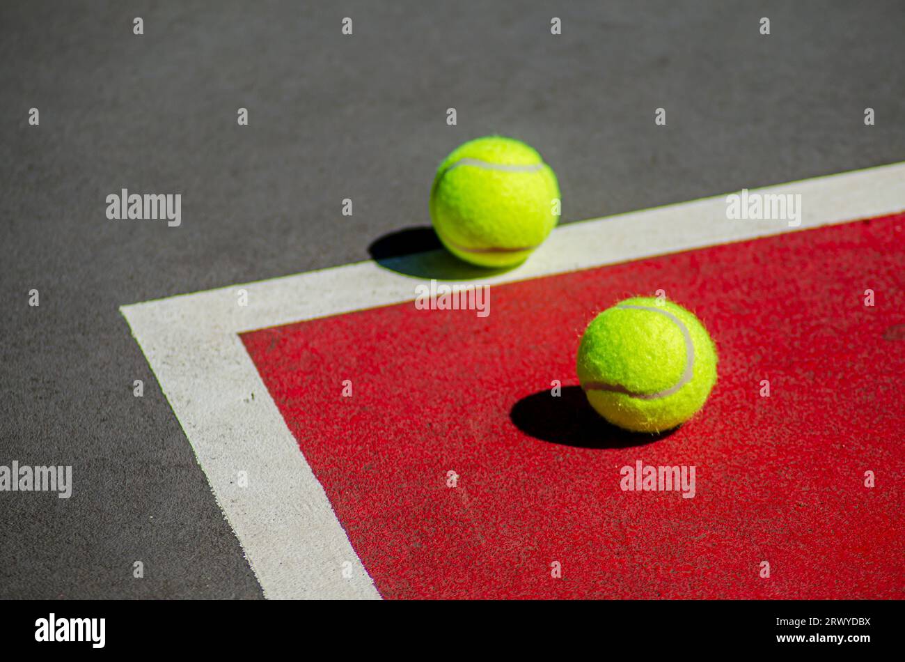 Two tennis ball in a red and gray tennis court. Racket sport Stock ...