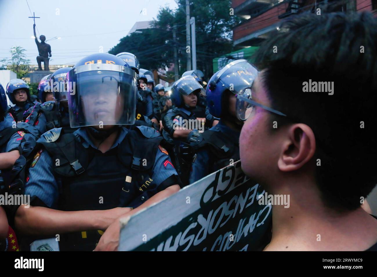 Protester faces a line of police officers during the demonstration. Extremists marched in Manila to mark the 51st anniversary of the declaration of Martial Law in the Philippines by the late dictator Ferdinand Emmanuel Edralin Marcos Sr. The Martial Law marked as tumultuous phase in Philippine history. Former President Marcos placed the entire Philippines under Martial Law that lasted from September 21, 1972 to January 17, 1981. During that time, Marcos cracked down on dissent and imprisoned thousands of his political critics. The dictator's family, with the power of Ferdinand Marcos Jr., a cu Stock Photo