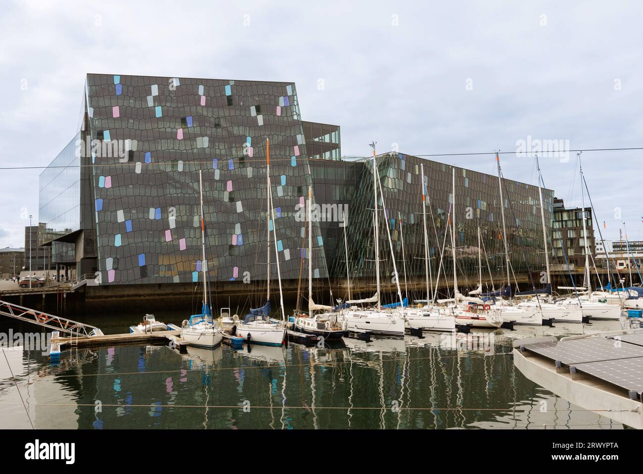 Harpa Reykjavik Concert Hall and Conference Centre with numerous pleasure crafts in the foreground, Iceland, Old Habour, Reykjavik Stock Photo