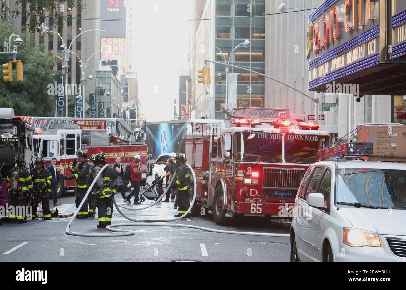 September 21, 2023, New York City, New York: (NEW) Ice Cream Van on fire. September 21, 2023, New York, USA: An Ice cream van stationed beside Radio City Music Hall on 50th street with 6th Avenue was on fire and with a total damage. Firemen were able to contain the fire but everything was destroyed. The salesman suffered no injures and stood afar watching the loss. Credit: Niyi Fote/Thenews2 (Foto: Niyi Fote/Thenews2/Zumapress) (Credit Image: © Niyi Fote/TheNEWS2 via ZUMA Press Wire) EDITORIAL USAGE ONLY! Not for Commercial USAGE! Stock Photo